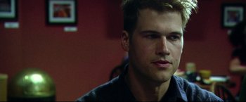 Movie still from “The Final Destination” (2009), directed by David R. Ellis – A person wearing a black shirt; Close Up shot, Over the shoulder angle