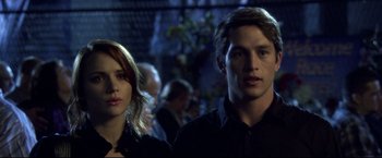 Movie still from “The Final Destination” (2009), directed by David R. Ellis – A man and a woman standing next to each other; Close Up shot, Low angle