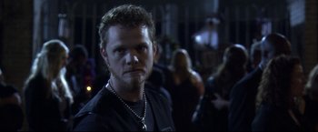Movie still from “The Final Destination” (2009), directed by David R. Ellis – A person wearing a black shirt; Close Up shot, Over the shoulder angle