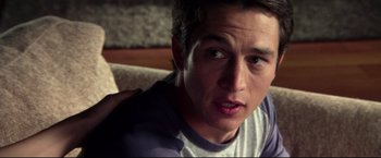 Movie still from “The Final Destination” (2009), directed by David R. Ellis – A person sitting on a couch; Close Up shot, Over the shoulder angle