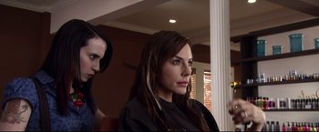 Movie still from “The Final Destination” (2009), directed by David R. Ellis – A woman sitting in front of another woman in front of a wall; Close Up shot, Over the shoulder angle