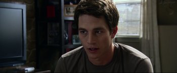 Movie still from “The Final Destination” (2009), directed by David R. Ellis – A young man is looking into the camera; Close Up shot, Over the shoulder angle