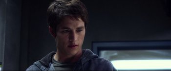 Movie still from “The Final Destination” (2009), directed by David R. Ellis – A young man with short brown hair wearing a gray hoodie; Close Up shot, Over the shoulder angle