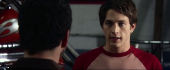 Movie still from “The Final Destination” (2009), directed by David R. Ellis – A man in a red shirt is talking to another man in front of a mirror; Close Up shot, Over the shoulder angle