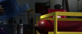 Movie still from “The Final Destination” (2009), directed by David R. Ellis – A fire extinguisher on a rack in a room; Wide shot, Low angle