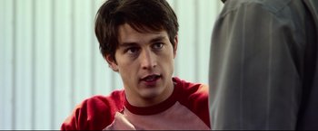 Movie still from “The Final Destination” (2009), directed by David R. Ellis – A man in a red shirt is looking at the camera; Close Up shot, Over the shoulder angle