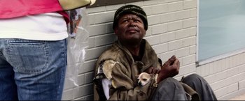 Movie still from “The Final Destination” (2009), directed by David R. Ellis – A man holding a small dog in his arms; Medium shot, High angle