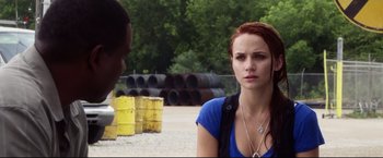 Movie still from “The Final Destination” (2009), directed by David R. Ellis – A woman standing next to a man in a parking lot; Close Up shot, Over the shoulder angle