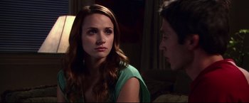 Movie still from “The Final Destination” (2009), directed by David R. Ellis – A woman sitting next to a man in a green shirt; Close Up shot, Over the shoulder angle