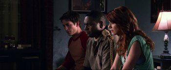 Movie still from “The Final Destination” (2009), directed by David R. Ellis – A group of young people sitting next to each other in a room; Medium shot, High angle