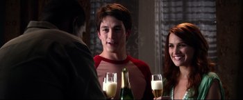 Movie still from “The Final Destination” (2009), directed by David R. Ellis – A group of people sitting at a table with drinks; Medium shot, Over the shoulder angle