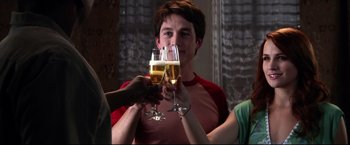 Movie still from “The Final Destination” (2009), directed by David R. Ellis – A group of people toasting with wine glasses; Medium shot, Over the shoulder angle