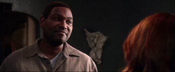 Movie still from “The Final Destination” (2009), directed by David R. Ellis – A man standing in front of a statue of a person; Close Up shot, Over the shoulder angle
