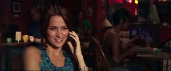 Movie still from “The Final Destination” (2009), directed by David R. Ellis – A woman smiles while talking on a cell phone; Close Up shot, Over the shoulder angle