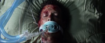 Movie still from “The Final Destination” (2009), directed by David R. Ellis – A man is laying in a hospital bed with blood on his face; Close Up shot, Overhead angle