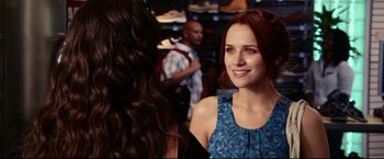 Movie still from “The Final Destination” (2009), directed by David R. Ellis – A woman with red hair is smiling at a store; Close Up shot, Over the shoulder angle