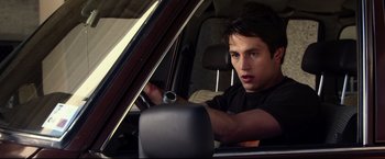 Movie still from “The Final Destination” (2009), directed by David R. Ellis – A man driving a car in the back of a vehicle; Close Up shot, Over the shoulder angle