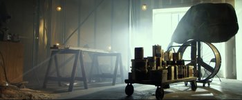 Movie still from “The Final Destination” (2009), directed by David R. Ellis – A cart full of cardboard boxes in a room; Wide shot, Low angle