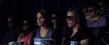 Movie still from “The Final Destination” (2009), directed by David R. Ellis – Two women are watching a movie in a theater; Close Up shot, Over the shoulder angle