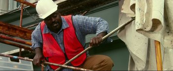 Movie still from “The Final Destination” (2009), directed by David R. Ellis – A man in a red vest is playing a drum set; Medium shot, Low angle