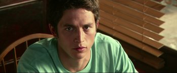Movie still from “The Final Destination” (2009), directed by David R. Ellis – A person wearing a green shirt; Close Up shot, Over the shoulder angle