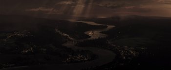 Movie still from “The Finest Hours” (2016), directed by Craig Gillespie – A river flowing through a city at night; Extreme Wide shot, High angle