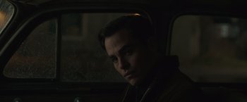 Movie still from “The Finest Hours” (2016), directed by Craig Gillespie – A man sitting in the back seat of a car looking out the window; Close Up shot, Over the shoulder angle