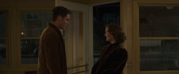 Movie still from “The Finest Hours” (2016), directed by Craig Gillespie – A man and a woman standing next to each other; Medium shot, Over the shoulder angle