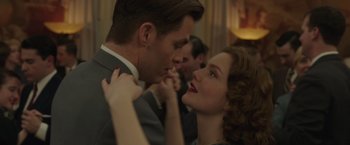 Movie still from “The Finest Hours” (2016), directed by Craig Gillespie – A man and a woman are holding hands in front of a crowd; Close Up shot, Low angle