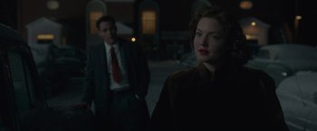 Movie still from “The Finest Hours” (2016), directed by Craig Gillespie – A man and a woman standing next to each other; Medium shot, Over the shoulder angle