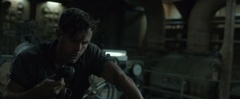 Movie still from “The Finest Hours” (2016), directed by Craig Gillespie – A man is looking down at his face in a dark room; Close Up shot, Low angle