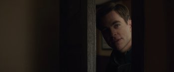 Movie still from “The Finest Hours” (2016), directed by Craig Gillespie – A person in a dark room; Close Up shot, Over the shoulder angle