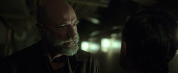 Movie still from “The Finest Hours” (2016), directed by Craig Gillespie – An older man with a beard and a mustache; Close Up shot, Over the shoulder angle