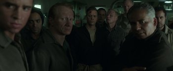 Movie still from “The Finest Hours” (2016), directed by Craig Gillespie – A group of men standing next to each other in a room; Medium shot, High angle