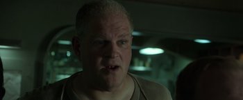 Movie still from “The Finest Hours” (2016), directed by Craig Gillespie – An older man with a goatee is looking at the camera; Close Up shot, Low angle