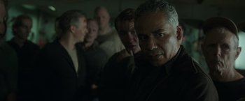 Movie still from “The Finest Hours” (2016), directed by Craig Gillespie – A group of men standing next to each other in a room; Close Up shot, Over the shoulder angle