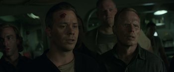 Movie still from “The Finest Hours” (2016), directed by Craig Gillespie – A group of men standing next to each other in a dark room; Close Up shot, Over the shoulder angle