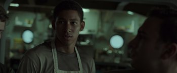 Movie still from “The Finest Hours” (2016), directed by Craig Gillespie – A man in an apron standing in front of a counter; Close Up shot, Over the shoulder angle