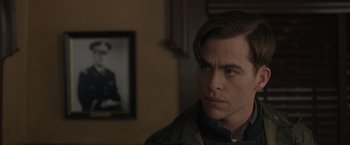 Movie still from “The Finest Hours” (2016), directed by Craig Gillespie – A person with a picture on the wall in the background; Close Up shot, Over the shoulder angle