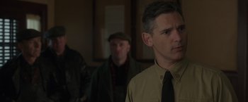 Movie still from “The Finest Hours” (2016), directed by Craig Gillespie – A man wearing a tie standing in front of another man; Close Up shot, Over the shoulder angle