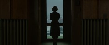 Movie still from “The Finest Hours” (2016), directed by Craig Gillespie – A woman standing in front of an open door; Medium shot, Low angle