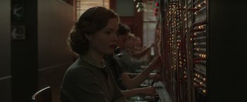 Movie still from “The Finest Hours” (2016), directed by Craig Gillespie – A group of people that are sitting at computers in a room; Close Up shot, Low angle