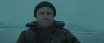 Movie still from “The Finest Hours” (2016), directed by Craig Gillespie – A man wearing a jacket and a hat in the snow; Close Up shot, Low angle