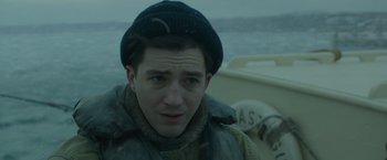 Movie still from “The Finest Hours” (2016), directed by Craig Gillespie – A man wearing a hat and a jacket on a boat in the water; Close Up shot, Low angle