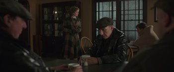 Movie still from “The Finest Hours” (2016), directed by Craig Gillespie – An older man and a younger woman sitting at a table; Medium shot, Over the shoulder angle