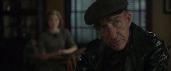Movie still from “The Finest Hours” (2016), directed by Craig Gillespie – An older man wearing a hat sitting in front of a woman; Close Up shot, Over the shoulder angle