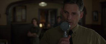 Movie still from “The Finest Hours” (2016), directed by Craig Gillespie – A man holding a microphone up to his face; Close Up shot, Over the shoulder angle