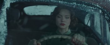 Movie still from “The Finest Hours” (2016), directed by Craig Gillespie – A woman sitting in the driver's seat of a car; Close Up shot, Low angle