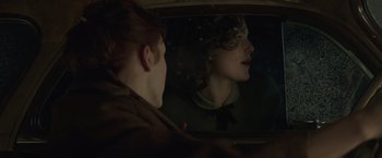 Movie still from “The Finest Hours” (2016), directed by Craig Gillespie – A woman sitting in the passenger seat of a car looking out the window; Close Up shot, Over the shoulder angle