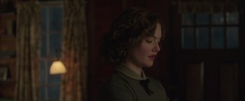 Movie still from “The Finest Hours” (2016), directed by Craig Gillespie – A woman with curly brown hair wearing a green shirt; Close Up shot, Over the shoulder angle